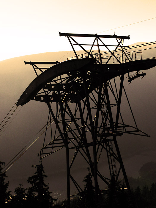 Grouse Mountain tram lift tower against the evening sun