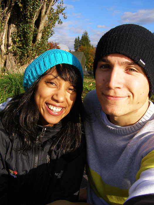 Couple sitting on a riverbank in Revelstoke